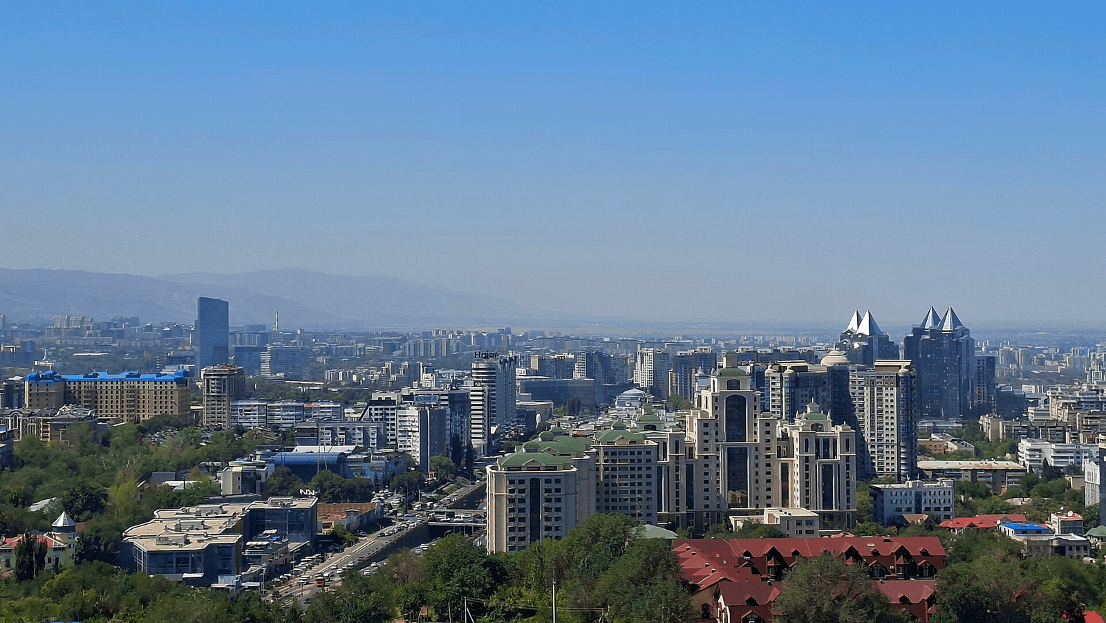 Public-domain image showing Almaty’s downtown skyline and the city viewed from Kok-Tobe Hill
